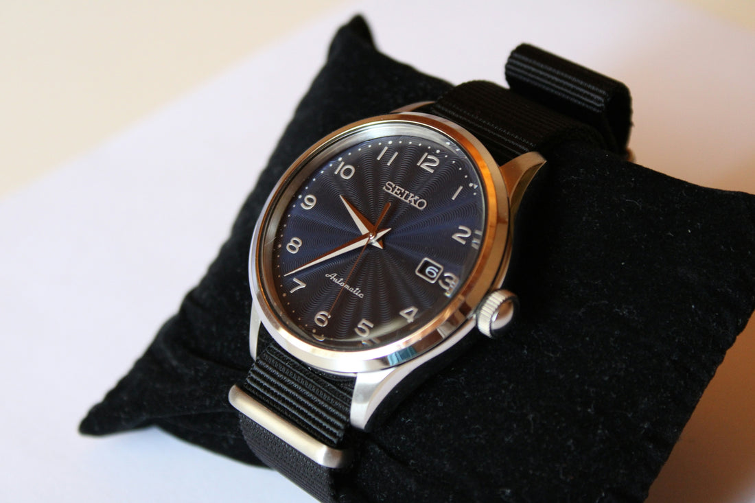 a black watch on a person's wrist