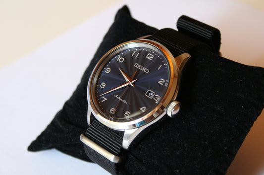 a black watch on a person's wrist
