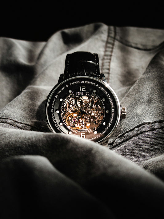 a close up of a watch on a person's lap